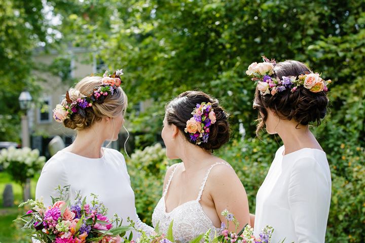 bride and bridesmaids showing their floral crowns