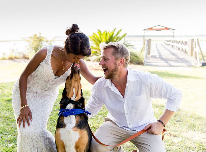 Bride and groom posing with their dog