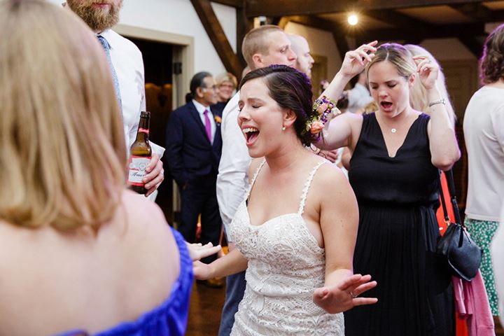 bride singing with her guests at reception
