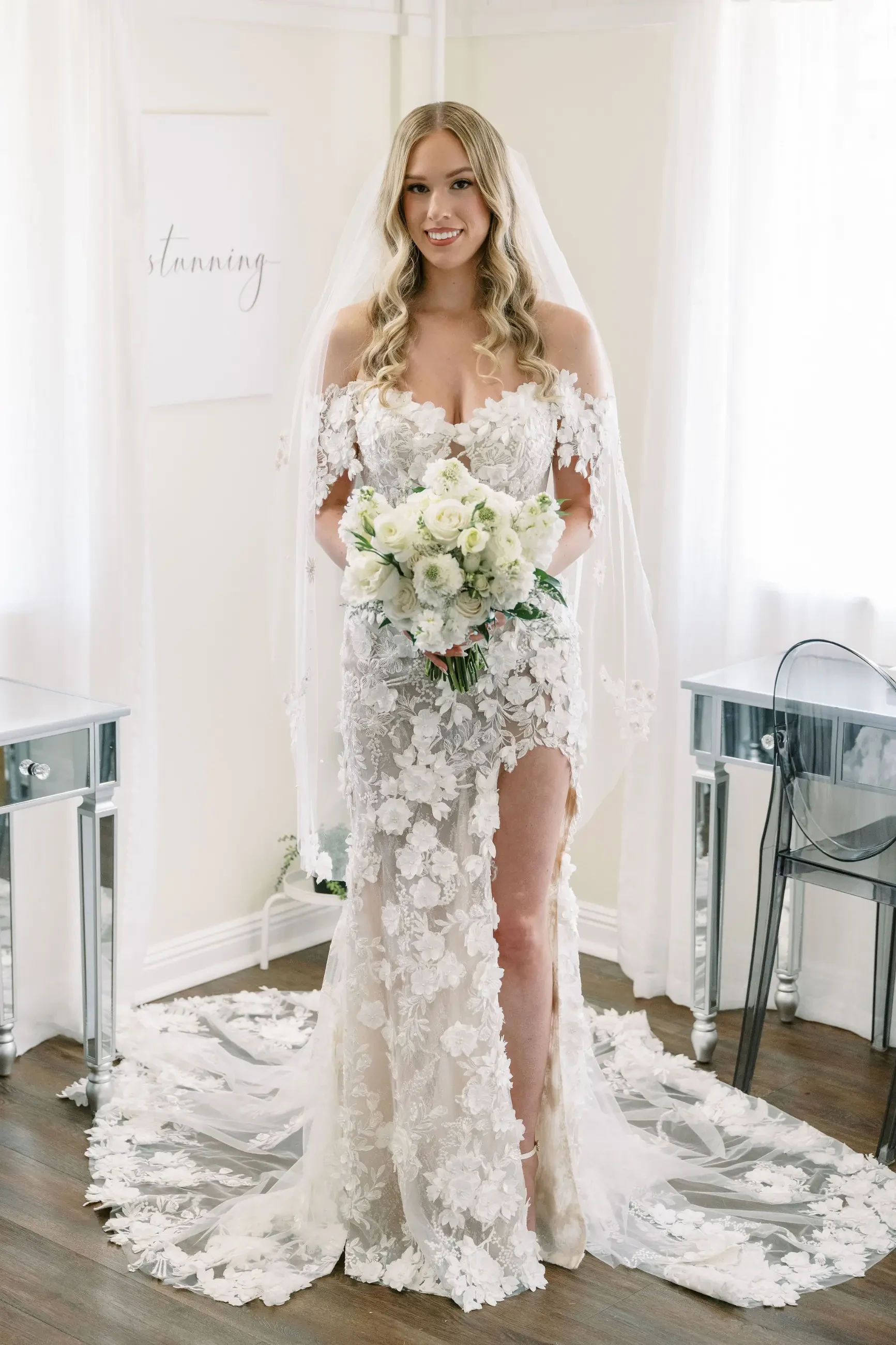 image shows a bride smiling and wearing her wedding dress from enchanting by mon cheri