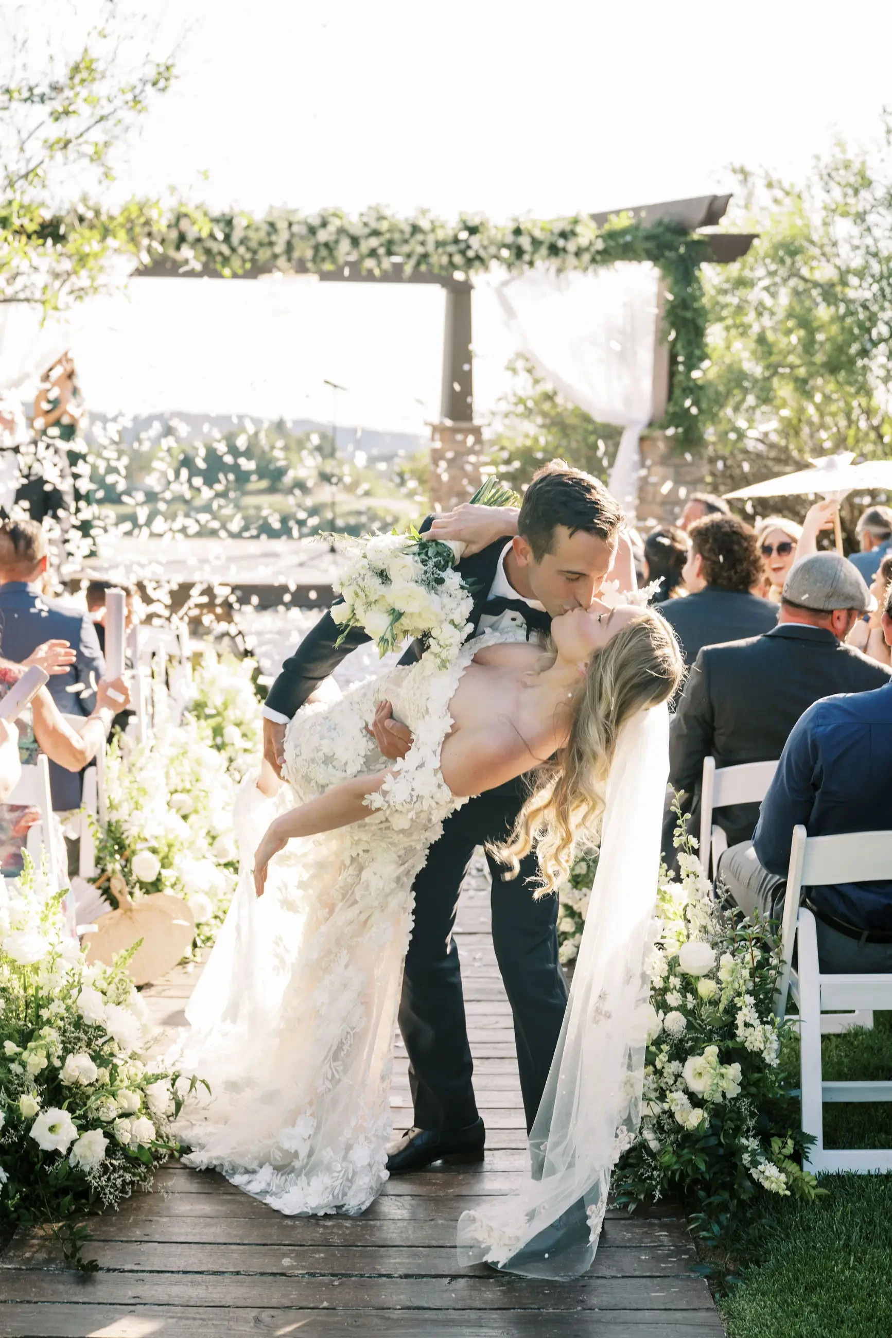 image shows bride and groom kissing after getting married