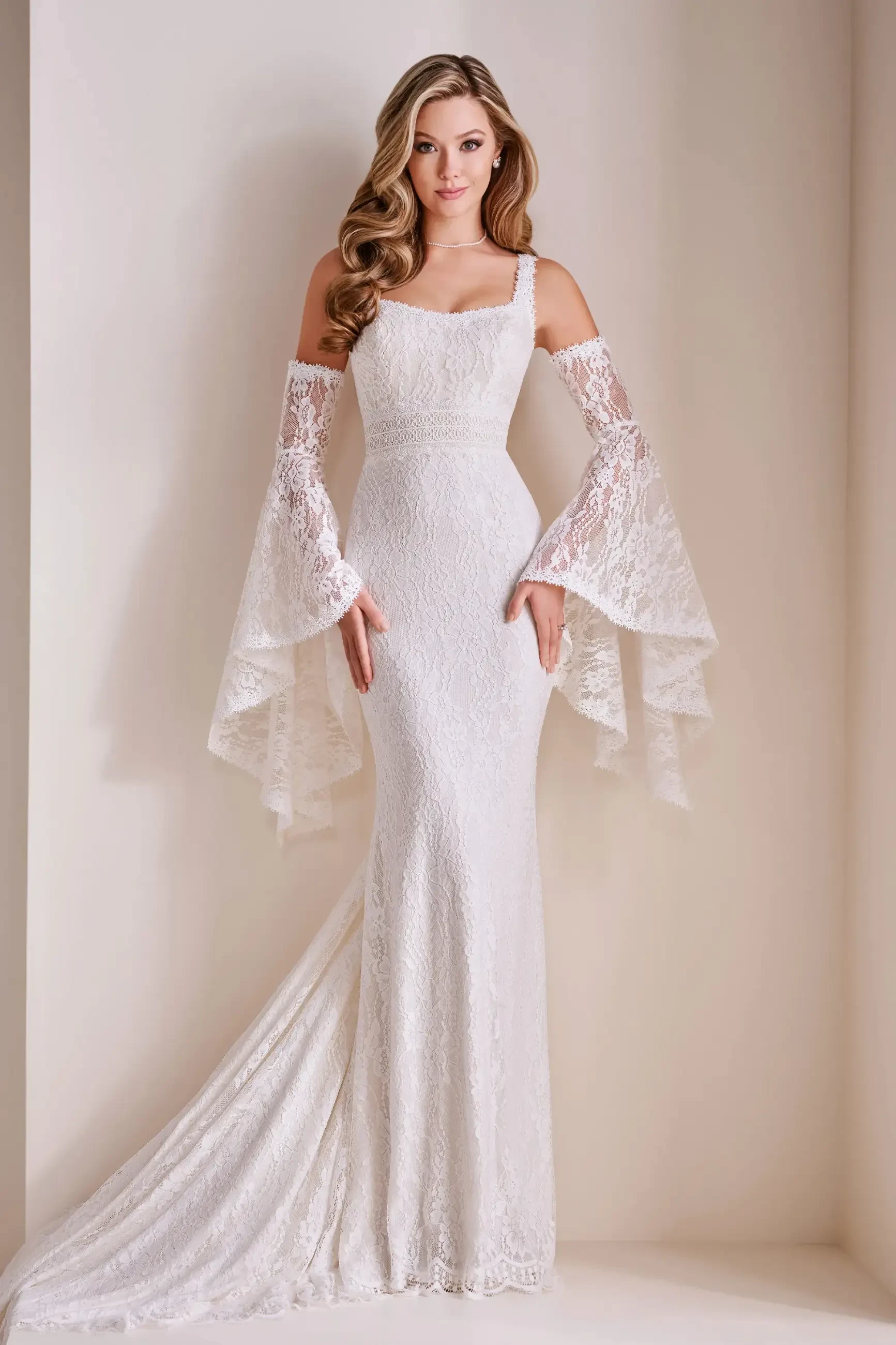 Model is wearing an allover lace wedding dress with detachable long boho sleeves