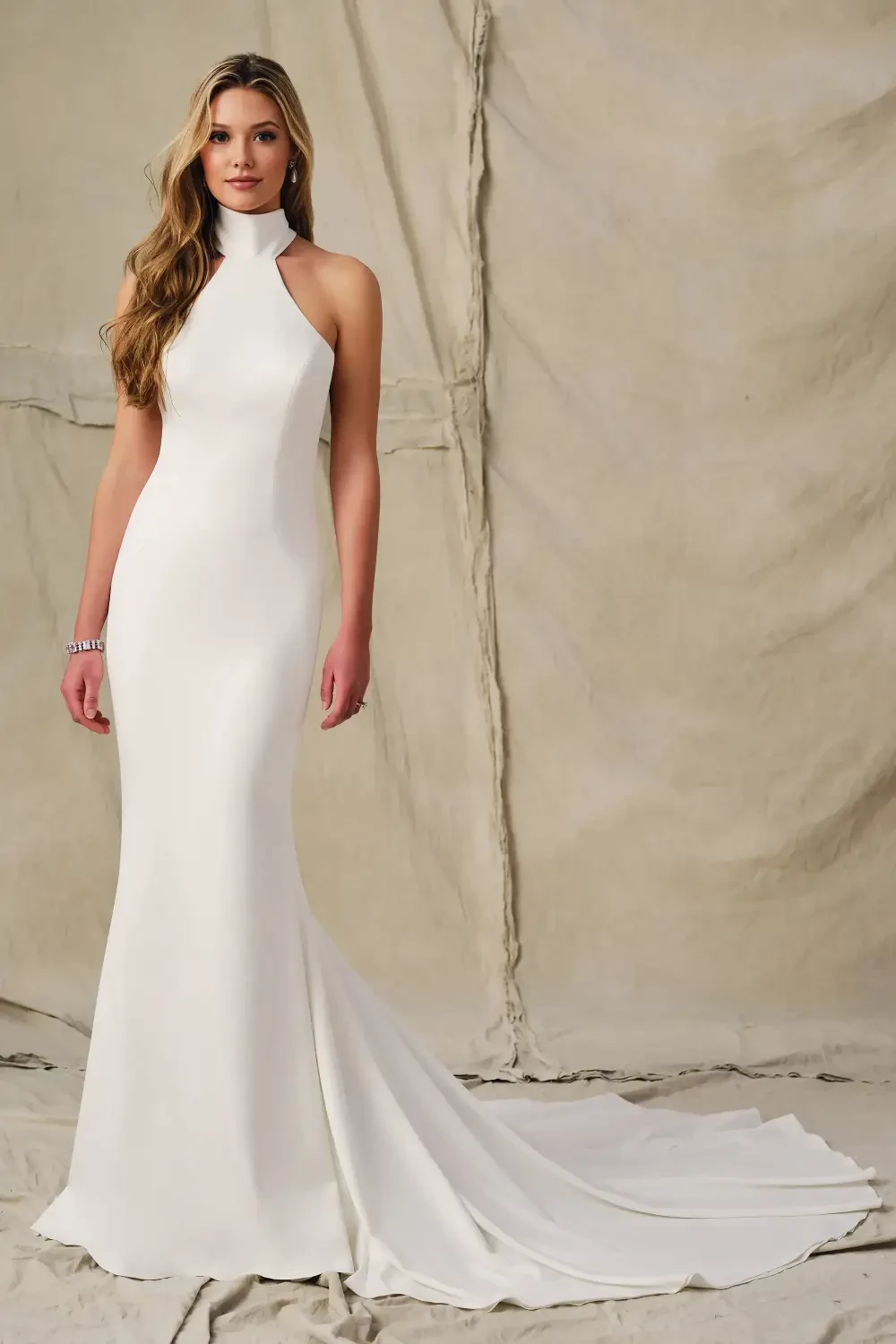 model is wearing a high neckline sleeveless bridal gown
