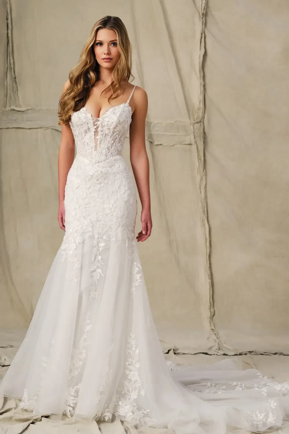 model is wearing a sleeveless sheath bridal gown with a sweetheart neckline