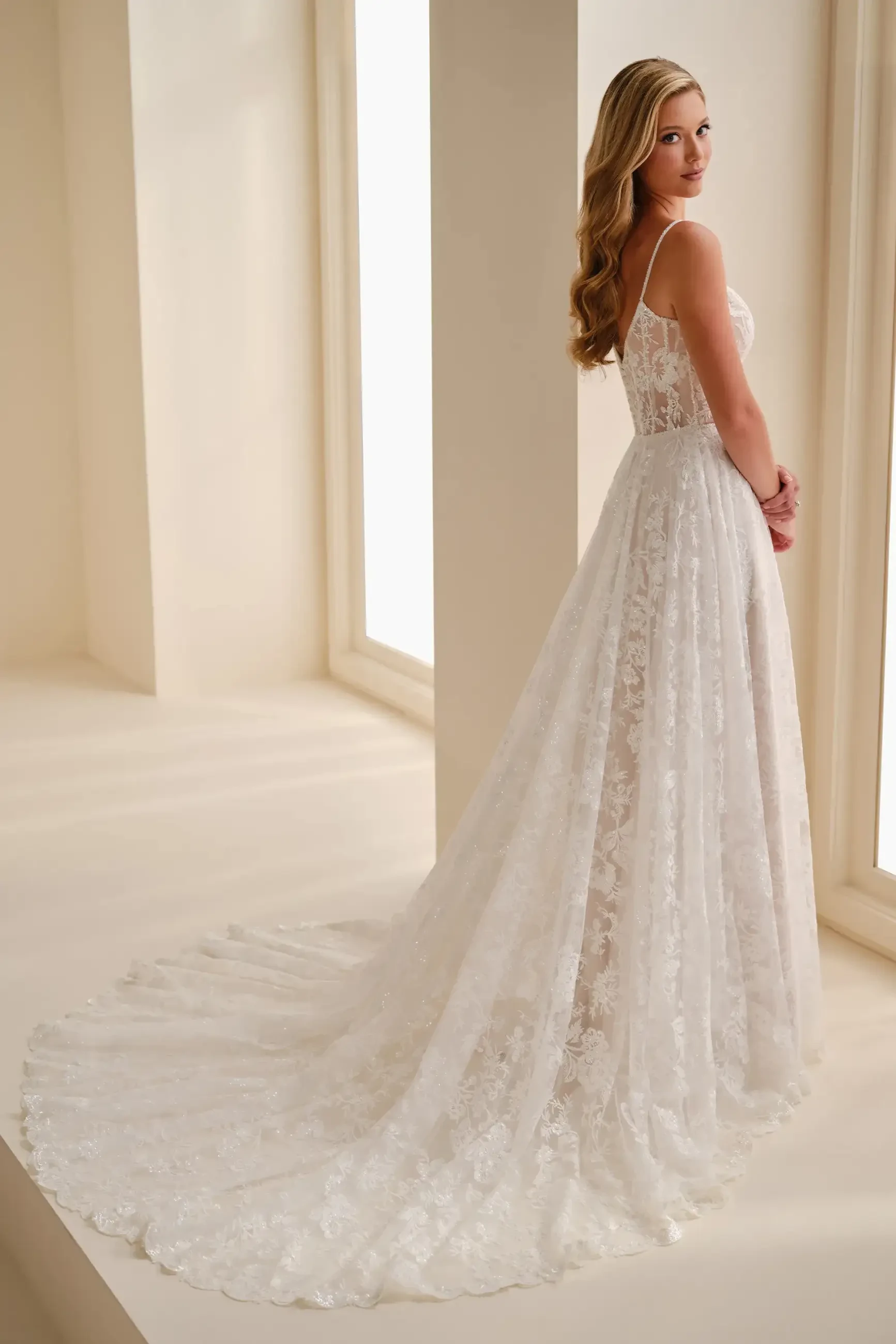 model is wearing a spaghetti strap a-line bridal gown