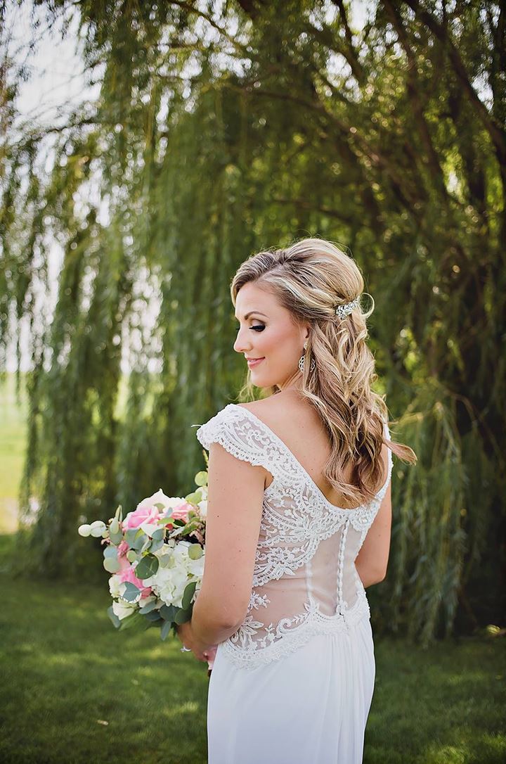 Bride showing the back of her wedding dress