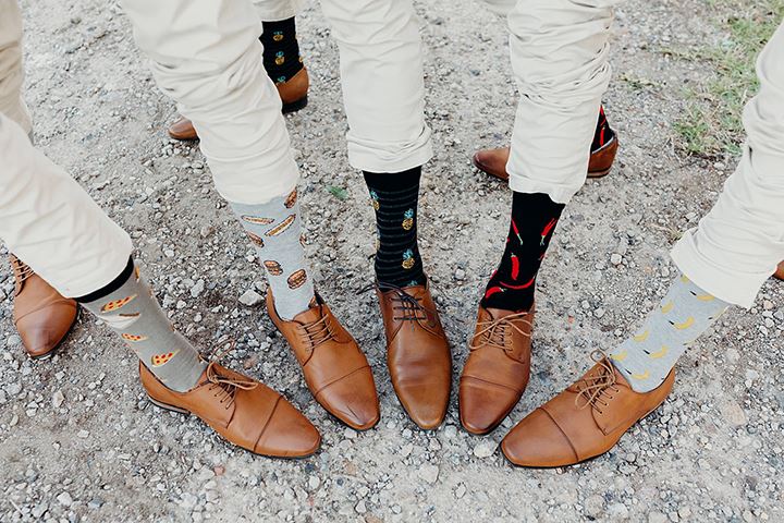 groomsmen showing off their funny socks