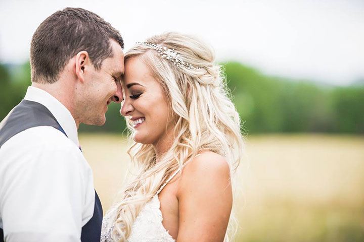 bride and groom smiling at each other